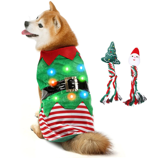 Dog wearing a Christmas-themed outfit with LED lights, next to two dog toys on a white background.