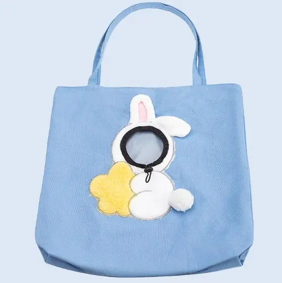 Blue pet carrier bag with a bunny and flower design on a light blue background