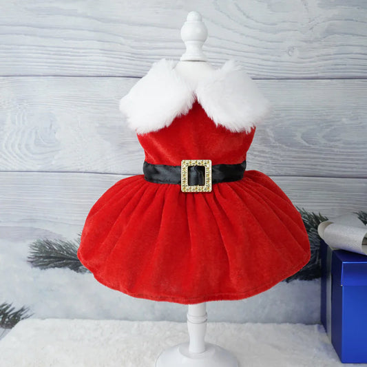Red dress with white fur collar on a mannequin against a winter-themed background