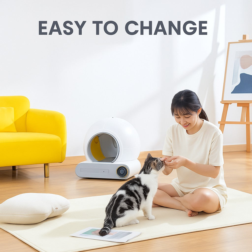 Woman sitting on the floor with a cat and an automatic litter box.