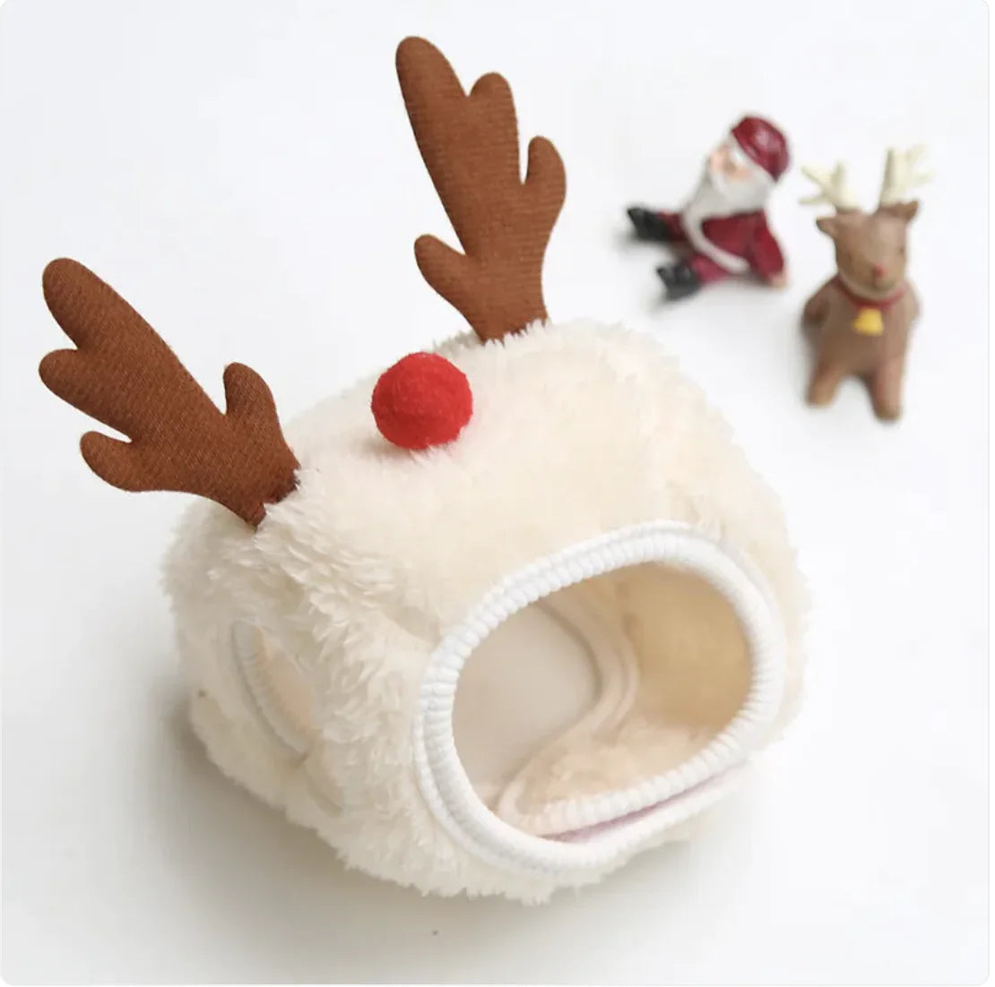 Reindeer pet hat with antlers and red nose on a white background