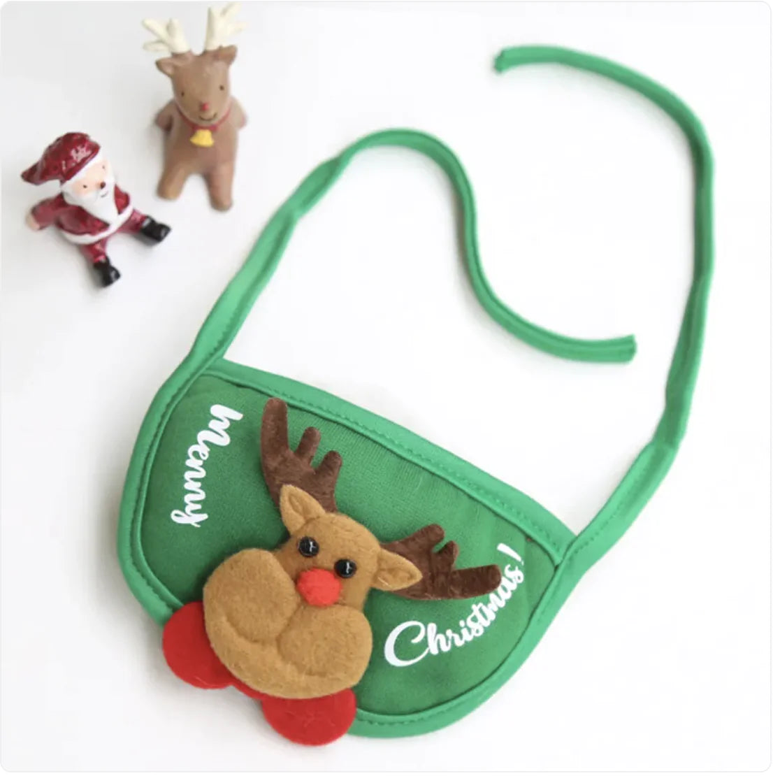 Green pet bib with reindeer design and 'Merry Christmas' text on a white background