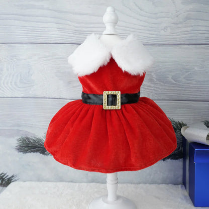 Red dress with white fur collar on a mannequin against a winter-themed background
